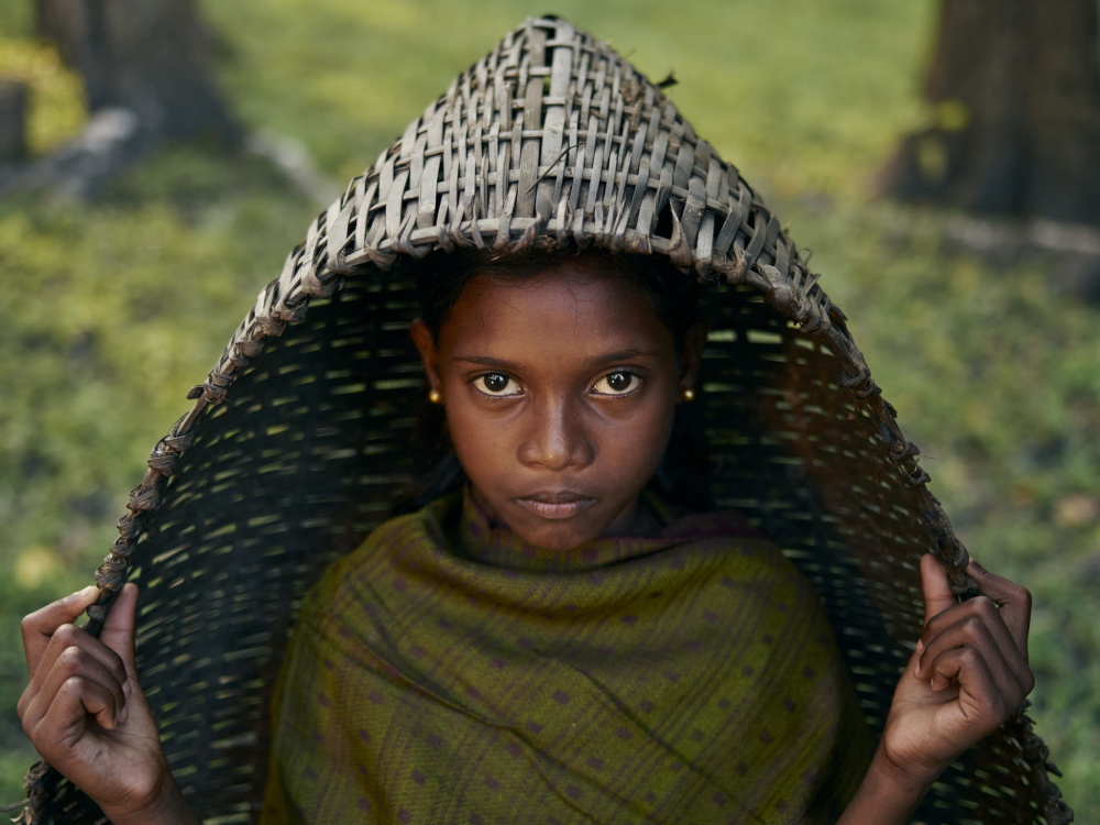 The Forest Gallery: Amitha inside a handwoven basket used to collect produce grown inside the forest.

